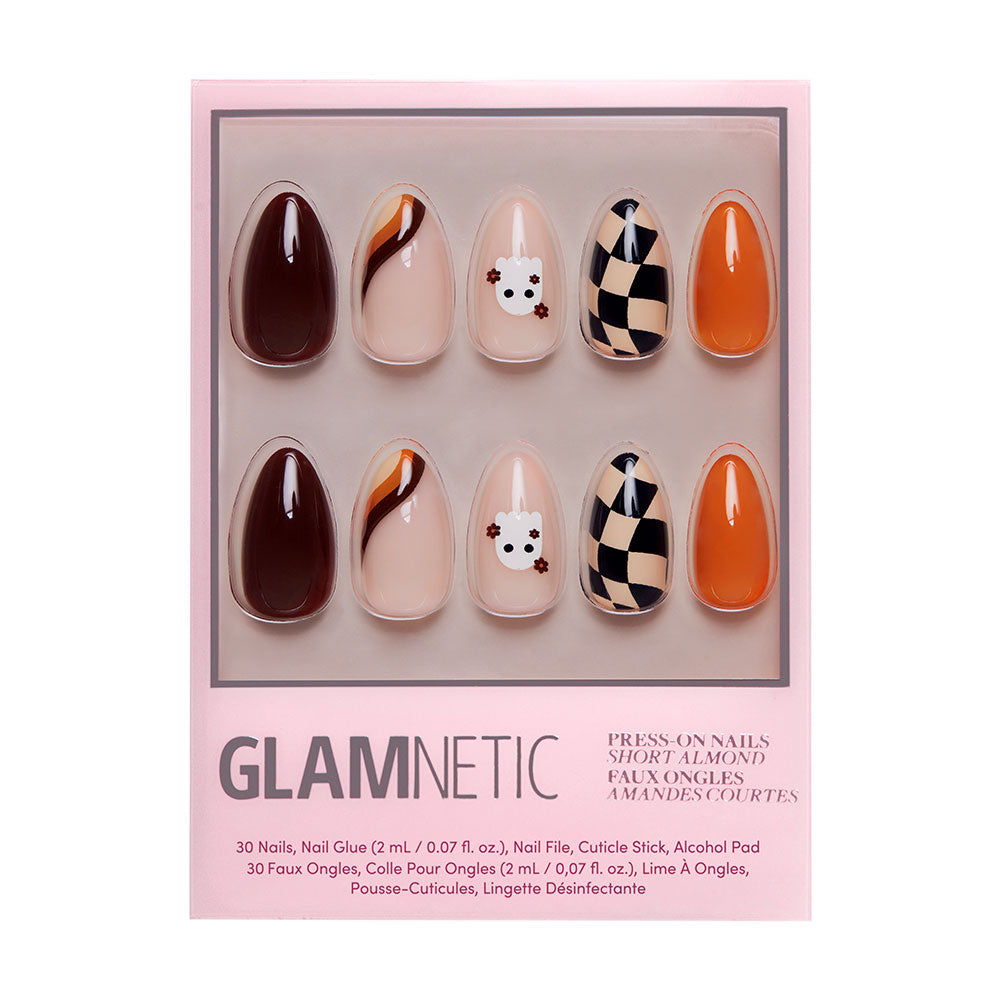 A set of almond-shaped Fall Boo nails by glamnetic in a pink box, with brown, black, orange, and nude cow faces, wavy patterns, and checkerboard prints—perfect for Halloween. Brand name glamnetic on the box.