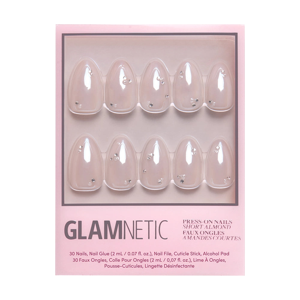 The First Dance vegan nail set by glamnetic features short almond-shaped nails in light pink with 3D pearl gems. Includes 30 nails, nail glue, file, cuticle stick, and alcohol pad. - Product image