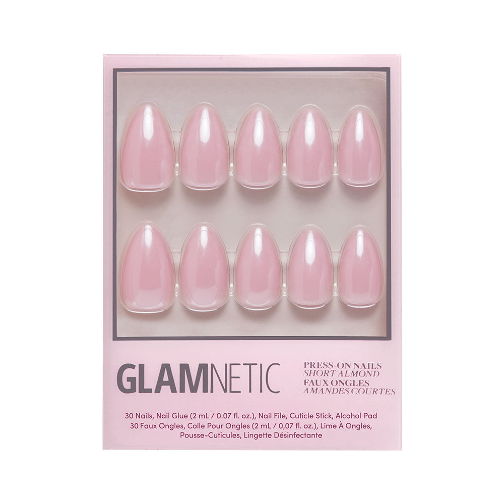 The First Kiss Nail Set by glamnetic includes 30 glossy blush pink short almond press-on nails, nail glue, file, cuticle stick, and alcohol pad for a flawless at-home manicure. - Product image