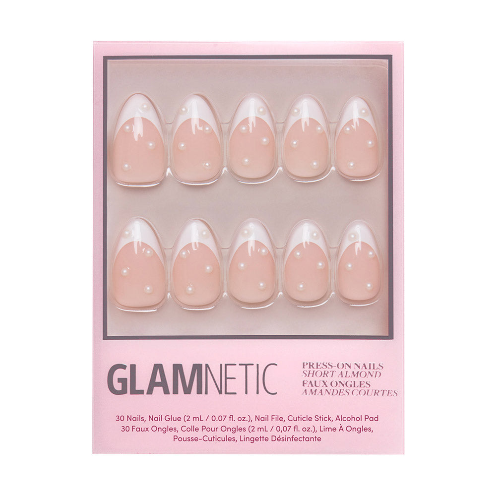 French Pearl by glamnetic includes 30 short almond nude nails in a pink box, arranged in two rows, plus nail glue, file, cuticle stick, and alcohol pad—perfect for bridal events. - Product image
