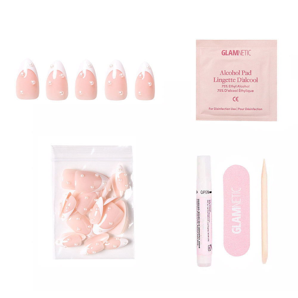 The glamnetic French Pearl set features pink short almond press-on nails with white tips and dots, plus an alcohol pad, nail file, cuticle stick, nail glue, and extra nails in a clear pouch—perfect for bridal events. Shown on a white background. - Product image