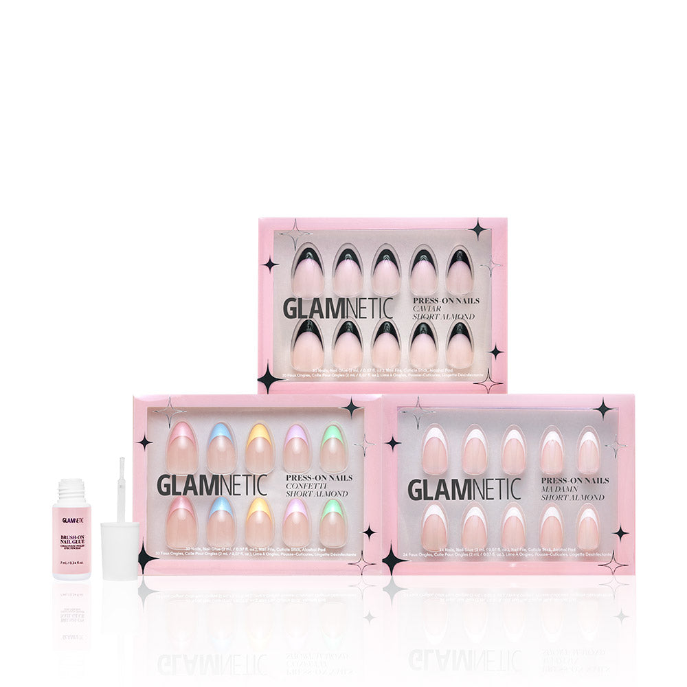Four glamnetic Frenchie Bundle press-on nail sets in pink boxes are stacked, with an open bottle of Glamnetic Nail Glue and its brush on the left—ideal for pairing with Caviar Confetti or easy removal using Press On Nail Remover. - Product image