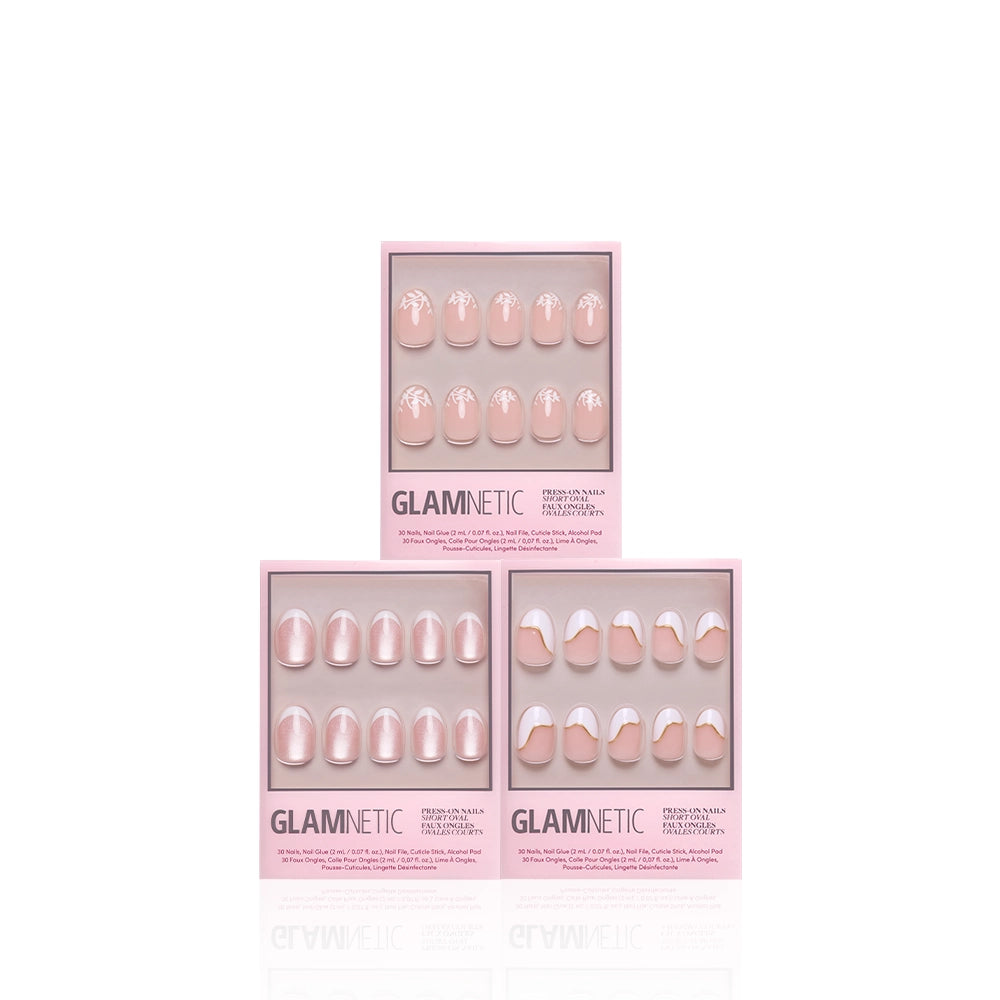 Three boxes of glamnetic Oui Oui Ovals salon-quality press-on nails are arranged in a pyramid shape. Each box displays a set of pink-toned French tip Oui Oui Ovals with varying white tip designs, set against a white background. - Product image