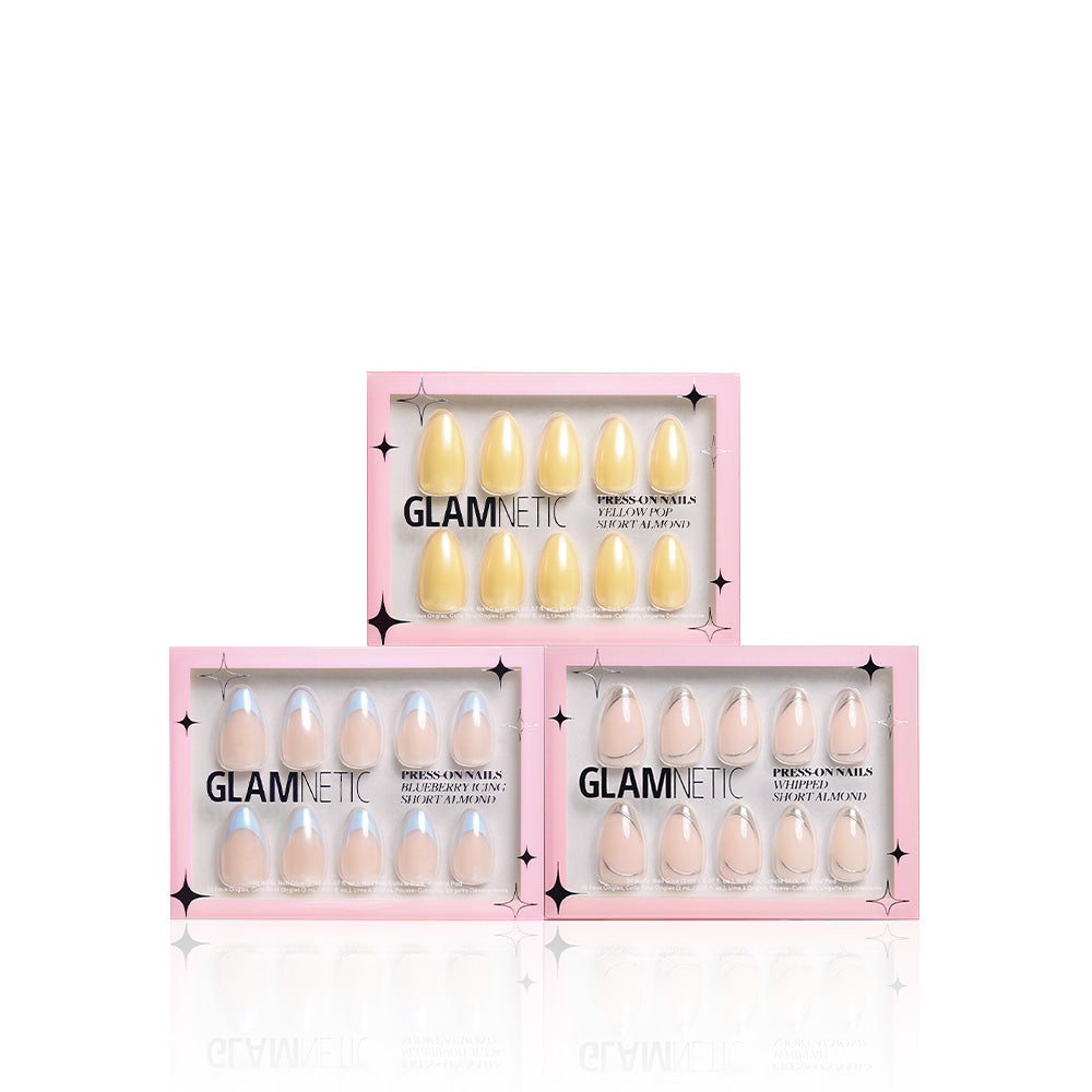 Three boxes of glamnetic Freshly Frosted press-on nails, each with a pink border and glossy glazed finish, are stacked in a triangle. Each vegan & cruelty-free Short Almond Nail Set features pastel shades. - Product image