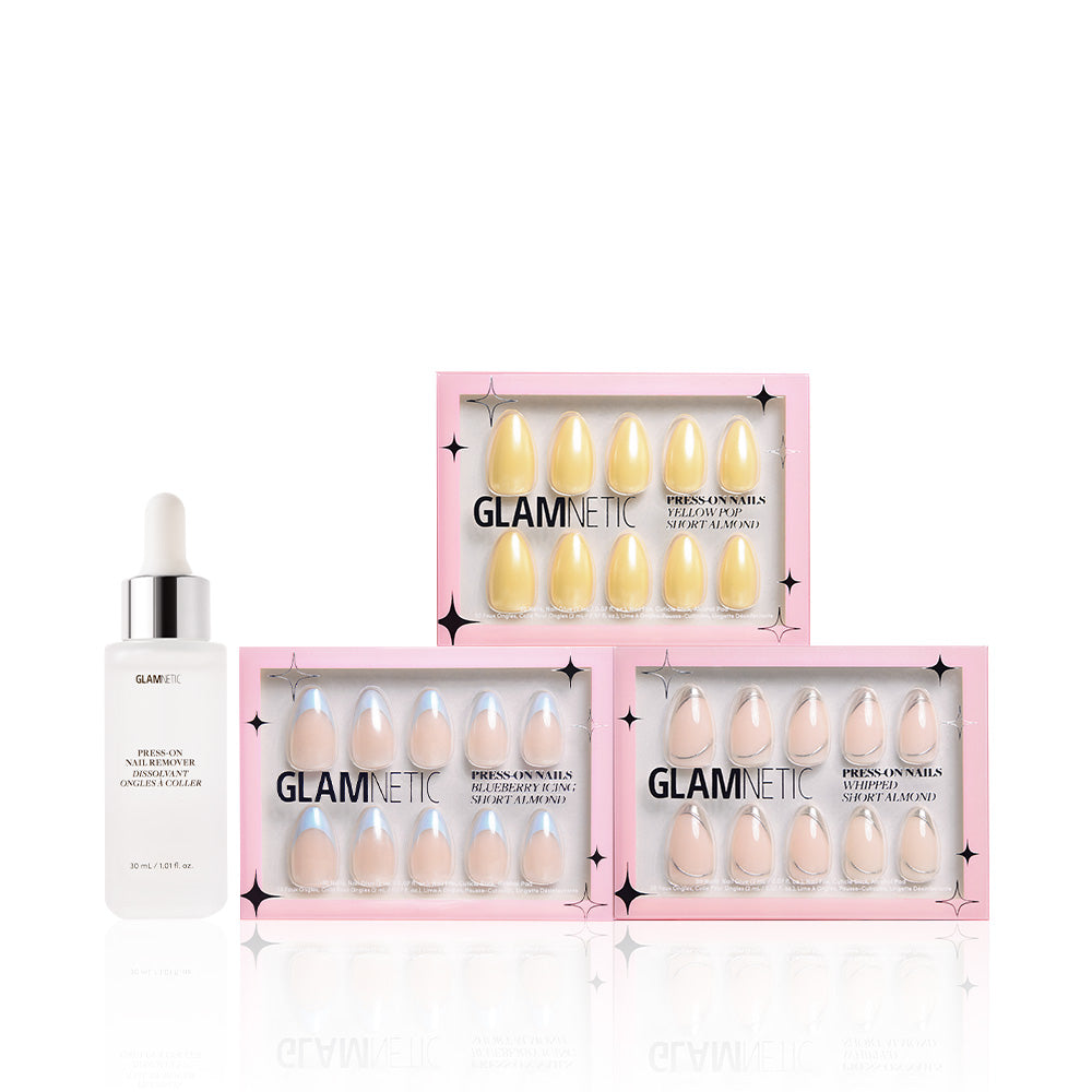 A white dropper bottle labeled glamnetic sits beside three Freshly Frosted Short Almond Nail Sets in pastel yellow, light blue, and soft pink with a glossy glazed finish, all in chic pink packaging. - Product image
