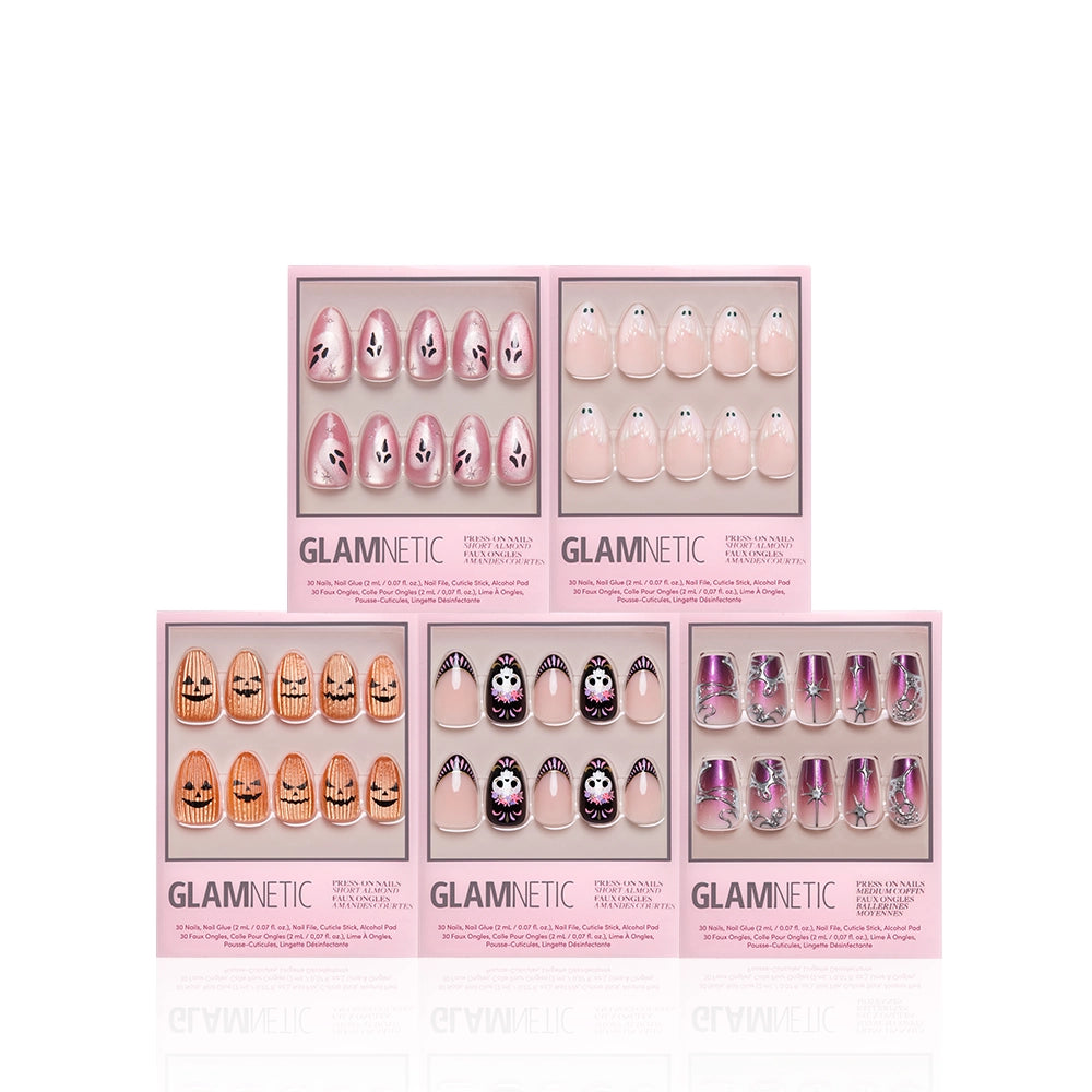 Six boxes of Glamnetic press-on nails are arranged in two rows. Each box contains a set of decorated nails in various pink, nude, and purple designs, some with faces, patterns, or marble effects. - Product image