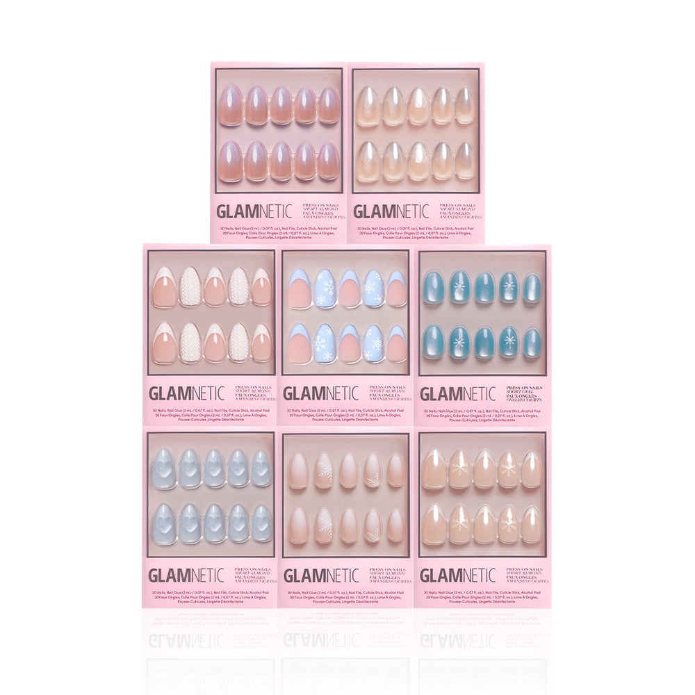 Nine boxes of glamnetic's Frozen Over press-on nails are arranged in a 3x3 grid, each showcasing a unique winter set of long, almond-shaped artificial nails in pastel and nude shades with glossy or glittery finishes. - Product image