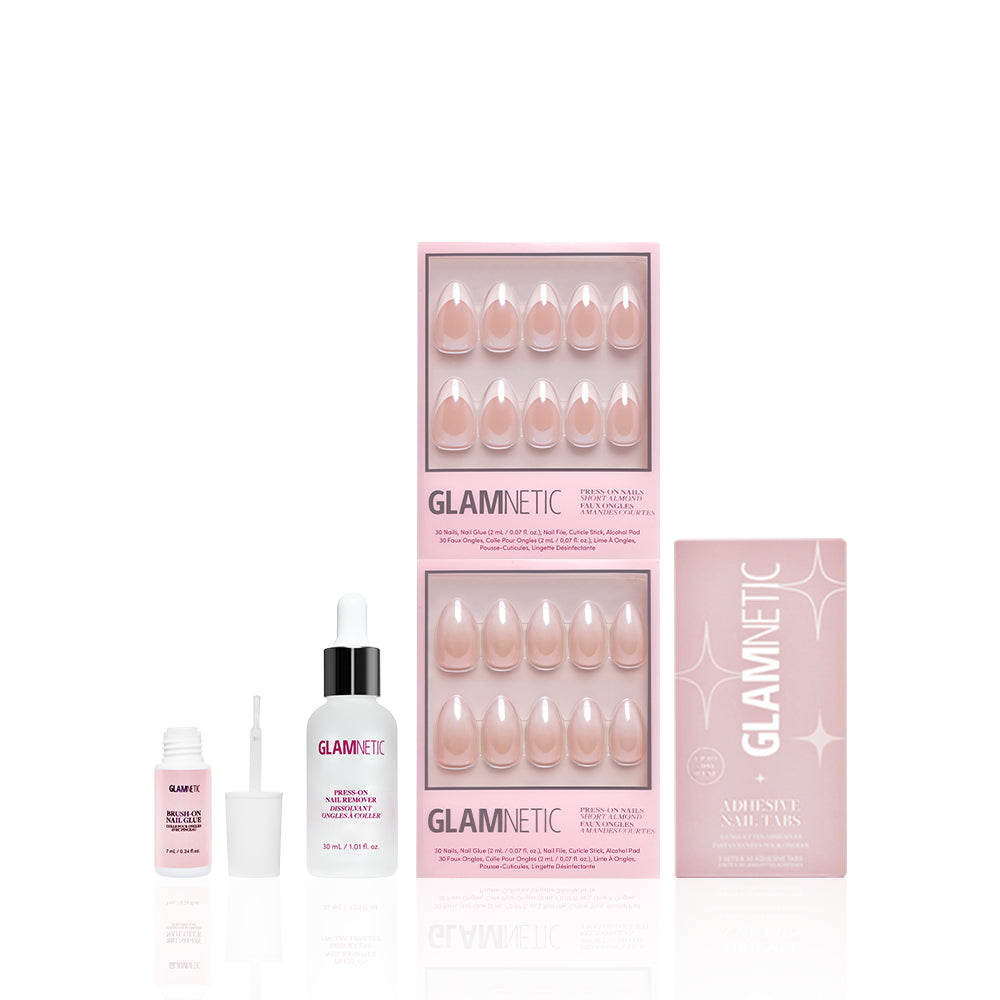 Glamnetic’s Glazed Almonds Glam set includes three boxes of salon-quality pink almond press-on nails, a nail glue bottle, brush applicator, and adhesive nail tabs—all beautifully arranged against a white background. - Product image