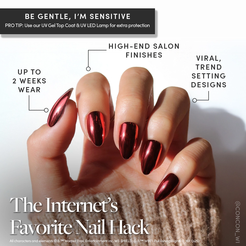 A hand with long, almond-shaped nails features glamnetic’s Godric Gryffindor™ in shiny metallic rose gold and a bold red chrome accent. Enjoy high-end salon finishes, trend-setting designs, and up to 2 weeks wear. - Product image