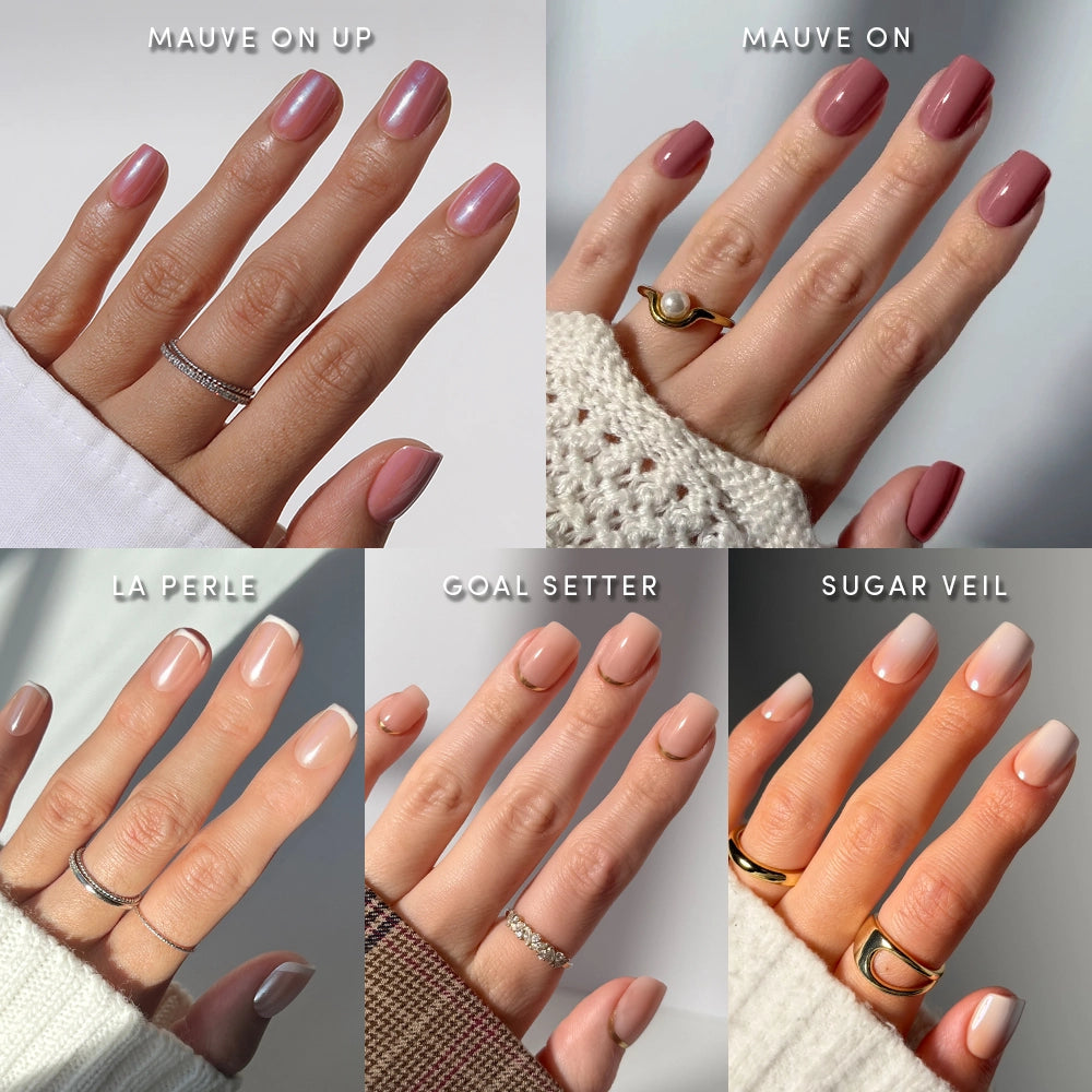 Five hands display different neutral nail polish shades—Gold Star Squovals by glamnetic—each hand adorned with simple rings that showcase the unique polish color. These salon-quality press-on nails from glamnetic offer an elegant alternative for those seeking a flawless manicure without the wait. - Product image