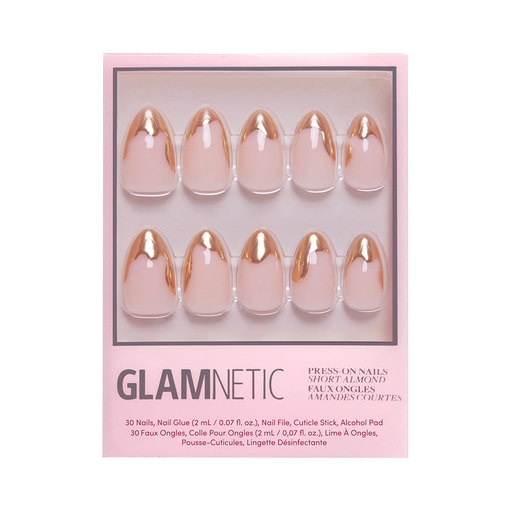 The glamnetic Golden Touch Nail Set includes ten short almond-shaped nude nails with abstract gold foil French tips, arranged in two rows in pink packaging with nail glue, a file, and other accessories advertised on the box. - Product image