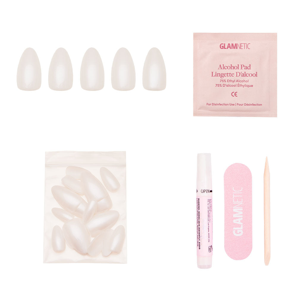 The glamnetic Hailey set includes five short almond nail tips, an alcohol pad, extra nails, glue, a pink nail file, and a wooden cuticle stick—all you need for the perfect Glazed Donut mani on a crisp white background. - Product image
