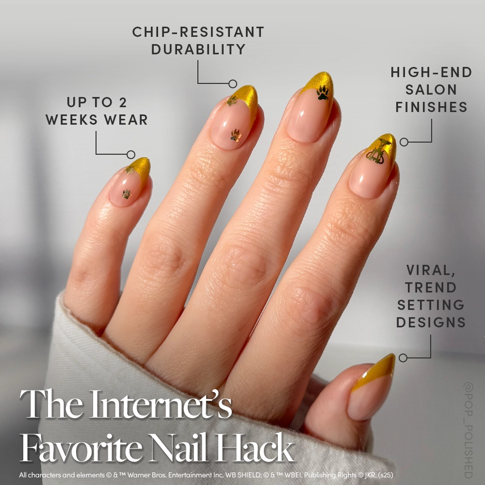 A close-up of a hand with long, almond-shaped nails featuring yellow velvet French tips and black paw prints. Text highlights chip-resistant durability, luxe finishes, and up to 2 weeks wear—part of the glamnetic Helga Hufflepuff™ Nail Set. - Product image