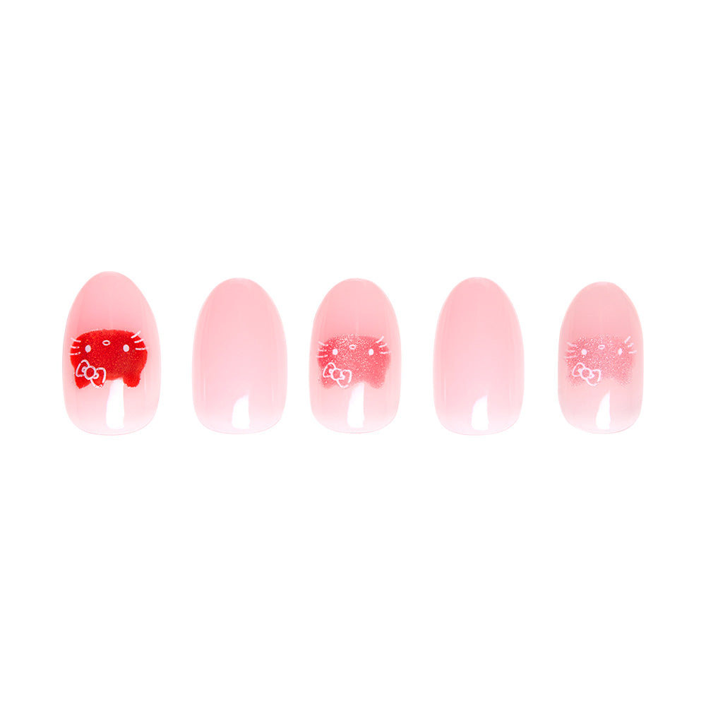 Five oval-shaped artificial nails from glamnetic’s Hello Kitty® collection in light pink; three display a red and white cartoon cat face with a bow. Two nails are solid pink. Vegan and cruelty-free. - Product image