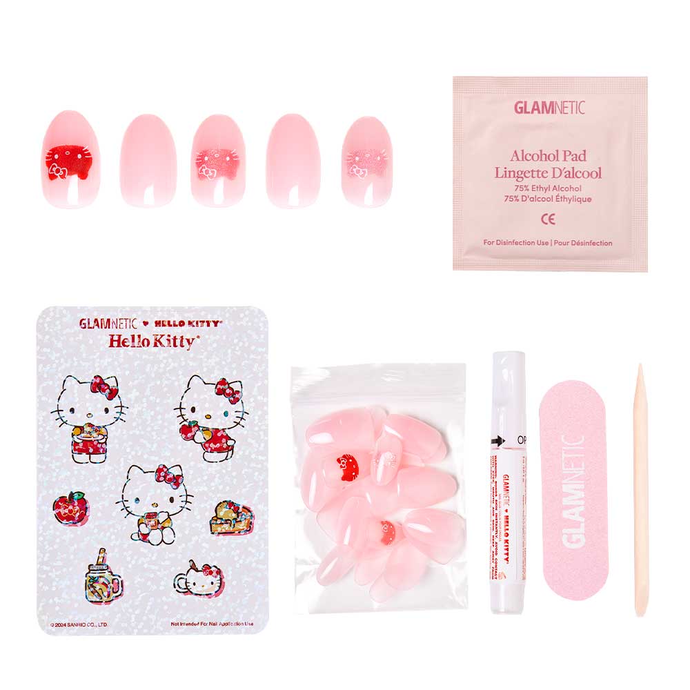 The glamnetic Hello Kitty® vegan & cruelty-free nail set includes pink oval press-on nails, a sticker sheet, alcohol pad, nail glue, pink file, and wooden cuticle stick—all arranged on a white surface. - Product image