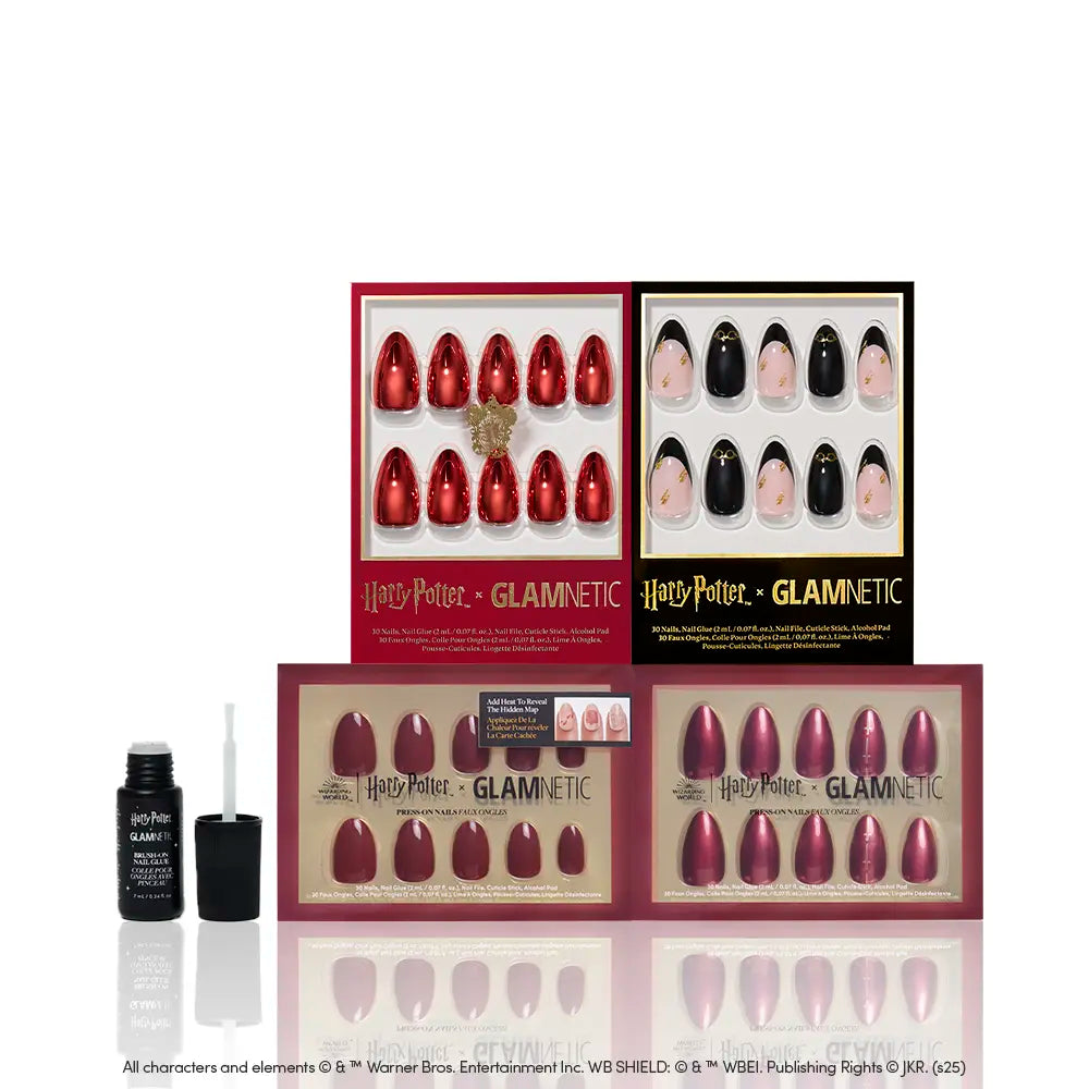 Five sets of glamnetic House Gryffindor™ press-on nails in assorted colors and designs, including a bold chrome red style, are displayed upright with a small black adhesive bottle featuring a brush applicator placed in front. - Product image