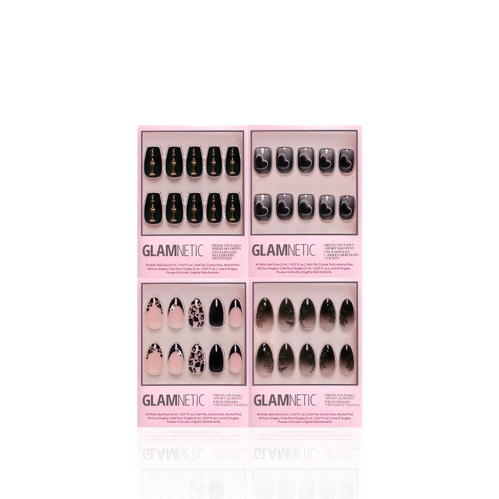 Four sets of glamnetic In The Shadows press-on nails in pink packaging, each featuring unique designs like black, marble, and gothic styles, are displayed against a white background. - Product image