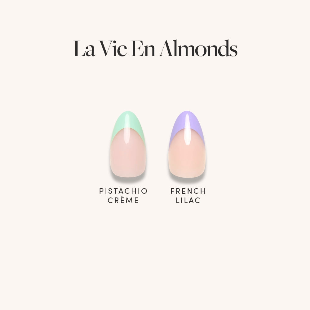 Two short almond press-on nails from glamnetic’s La Vie en Almonds are shown: one features a pastel mint green tip, the other a pastel lilac tip, both on a nude base for an elegant, trendy look. Text reads La Vie en Almonds. - Product image
