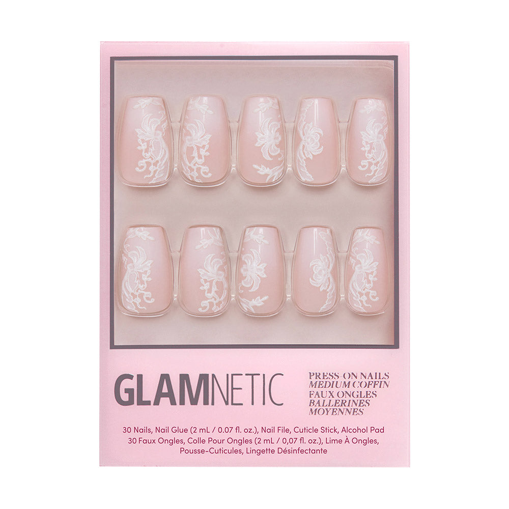 The glamnetic Lace Blush boxed set includes 30 coffin nails in pale pink with white floral and lace designs, nail glue, file, cuticle stick, and alcohol pad for easy application.