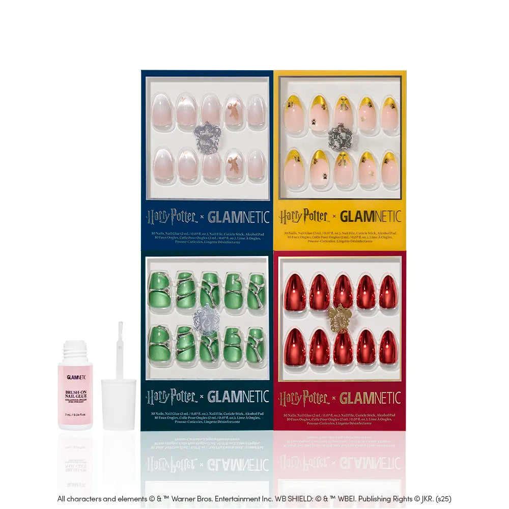 Four boxes of glamnetic's Legacy Legends nail set showcase house-inspired nails in blue, yellow, green, and red with unique designs. A nail glue bottle with applicator sits to the left of the boxes on a white background. - Product image