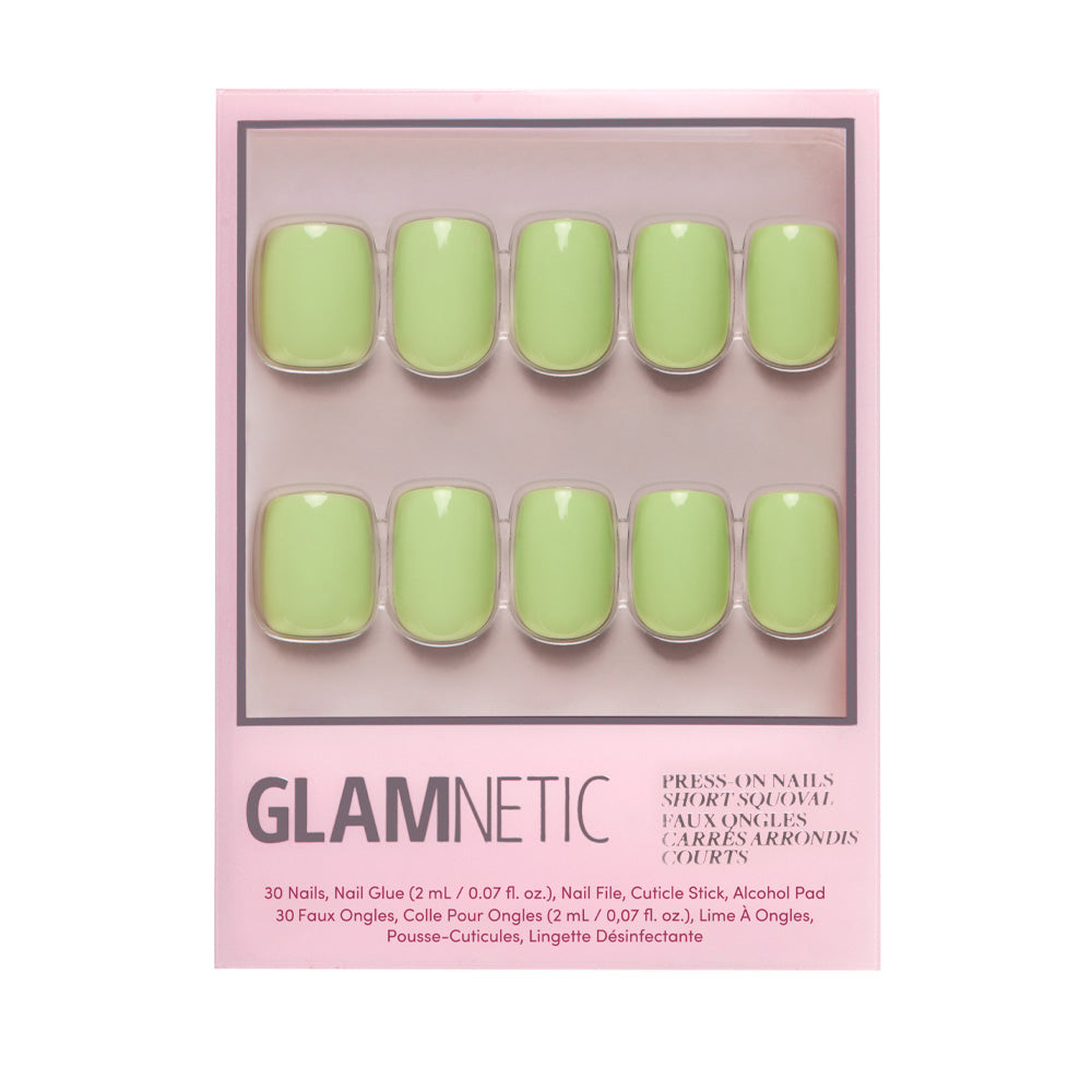 A box of glamnetic Light Sage press-on nails in a short squoval shape with a pastel green glossy finish. Packaging shows ten nails in two rows and includes product details in English and French. - Product image