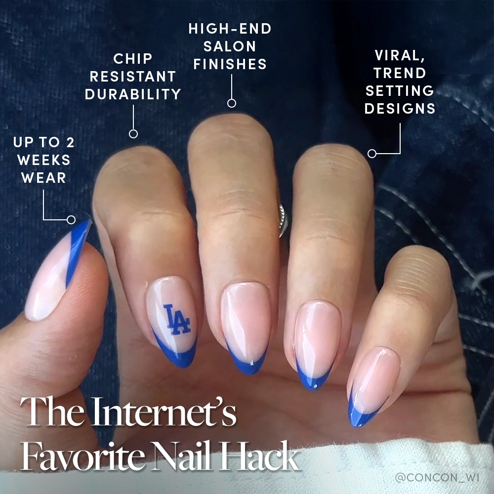 A hand with almond-shaped nails shows off a blue French tip mani and a LA Dodgers logo. Try the glamnetic Los Angeles Dodgers Press-On Nail Set for up to 2 weeks wear, chip resistance, luxe finishes, and on-trend designs. - Product image