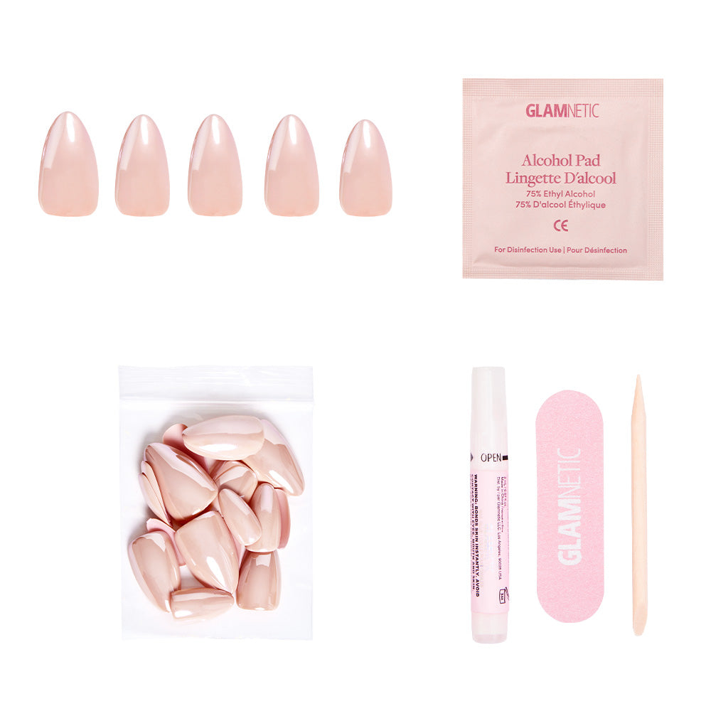 The glamnetic Los Angeles Nail Set includes short almond nude-blush press-on nails, an alcohol pad, extra nails, nail glue, a pink nail file, and a wooden cuticle stick—all displayed on a white background. - Product image