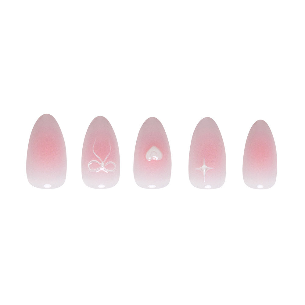 Lovers Knot by glamnetic features five almond nails with a soft pink ombre and unique white accents: a raised bow, heart, swirl, star, plus one plain semi-transparent nail. - Product image