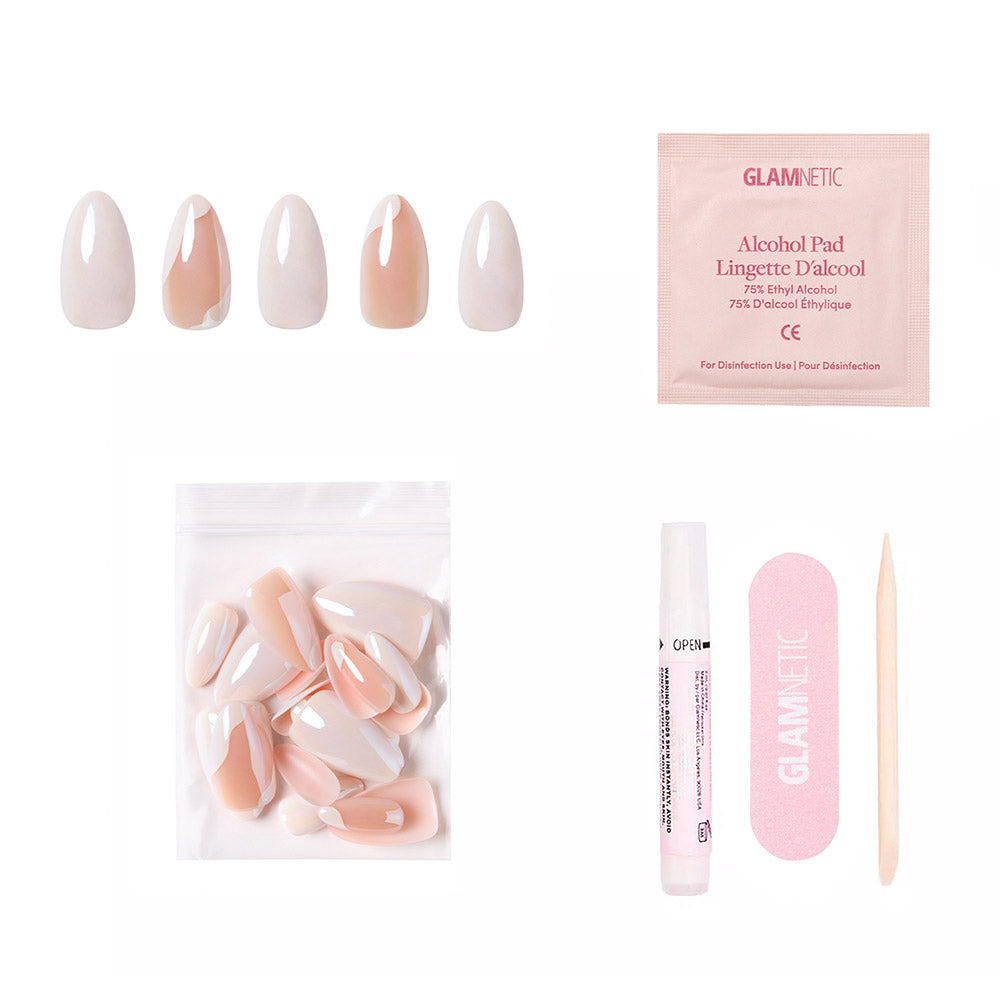 The Lovey Dovey by glamnetic features almond press-on nails in nude and white minimalist tones, plus an alcohol pad, mini nail file, cuticle stick, nail glue, extra nails, and a resealable bag—all displayed on a white background. - Product image