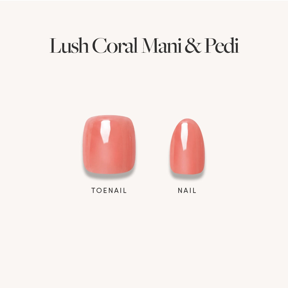 Two glossy coral press-on nails by glamnetic—one wider, squarer toenail and one narrower, rounder fingernail—both with a glazed finish. Set against a light background with the text "Lush Coral Mani & Pedi. - Product image