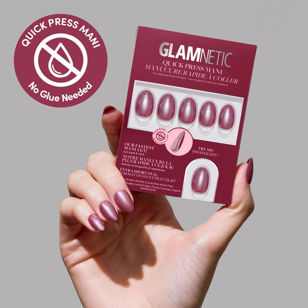 A hand with shiny mauve Mauve Muse press-on nails holds a glamnetic Quick Press Mani box labeled "No Glue Needed," showing matching stick-on nails. A circular label highlights the no-glue feature.