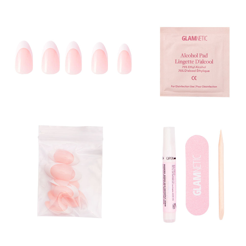 The glamnetic Ma Damn press-on nail kit includes five pink almond nails, an alcohol pad, extra tips, nail glue, a pink file, and a wooden cuticle stick—cruelty-free and arranged on a white background. - Product image