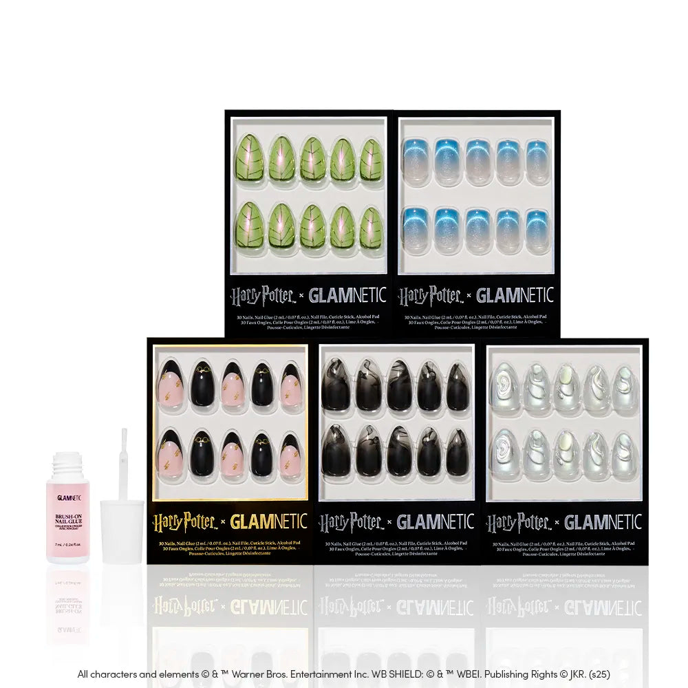 Six boxes of glamnetic's Magic & Mystery press-on nails, featuring enchanting Harry Potter designs, are arranged in two rows. Nail glue and a manicure stick are positioned to the left in front of the nail sets. - Product image