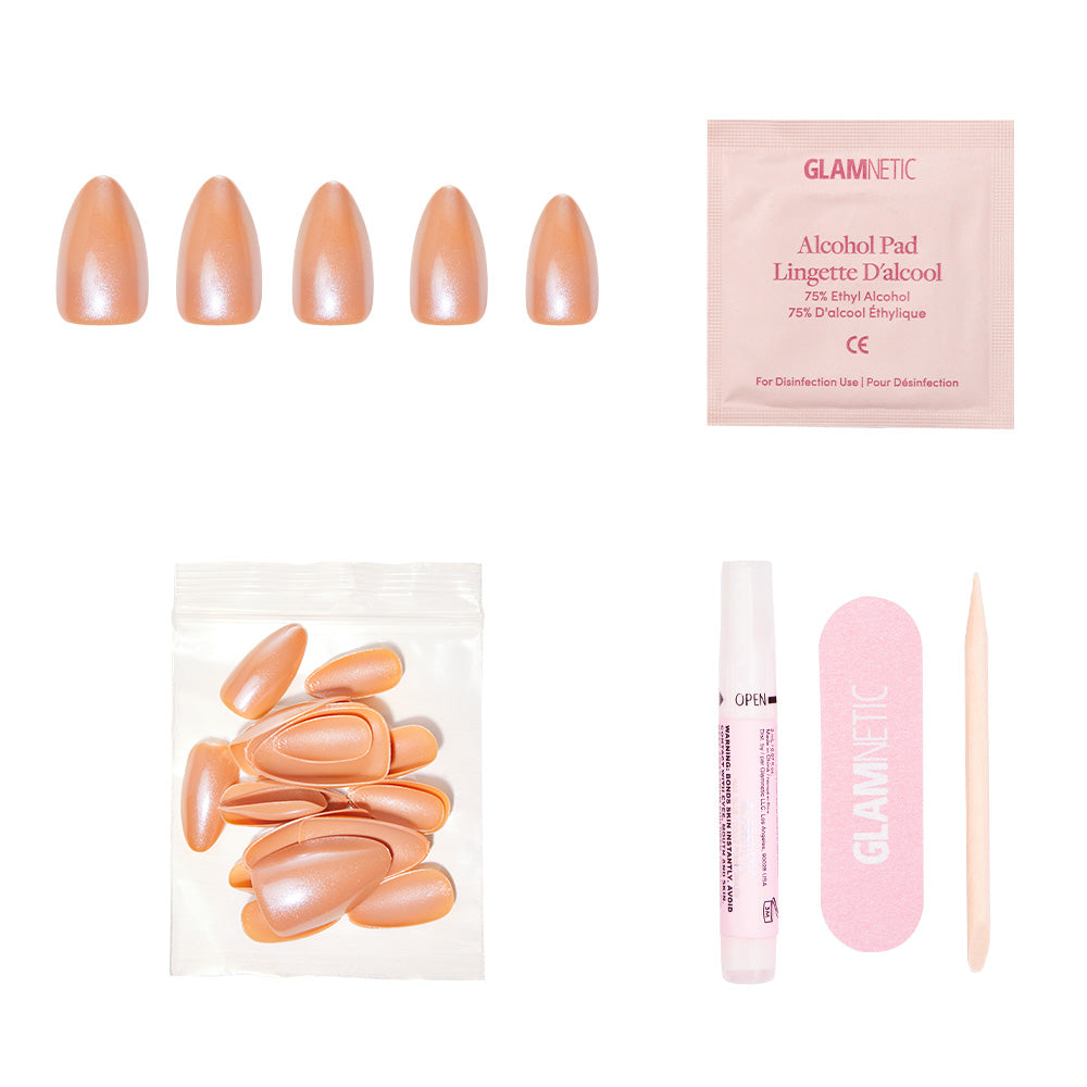 The glamnetic Maple Glaze set includes shimmering peach short almond nails, an alcohol pad, clear glue tube, pink nail file, wooden cuticle stick, and extra nails—beautifully displayed on a white background. - Product image