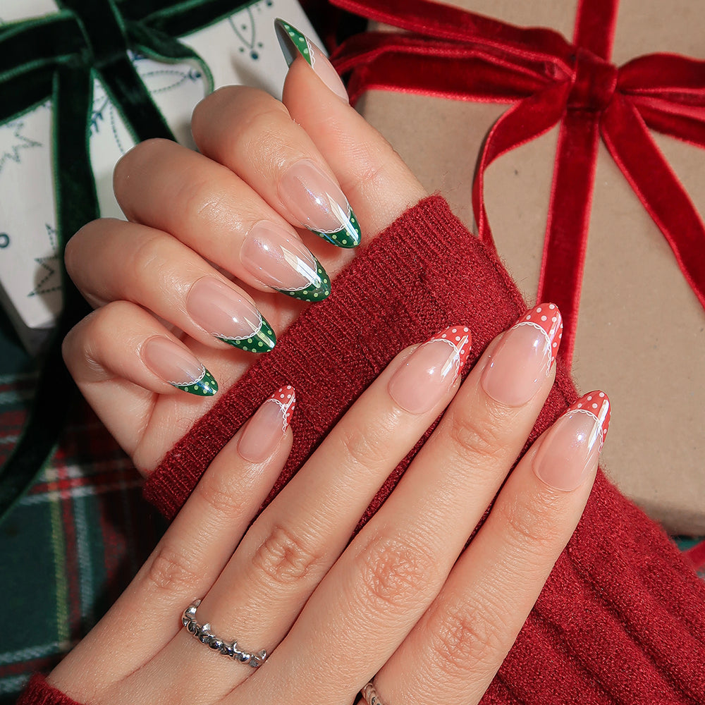 Short almond Matching PJs press-on nails featuring a glossy French tip design with green polka dots on one hand and red polka dots on the other. - Product image