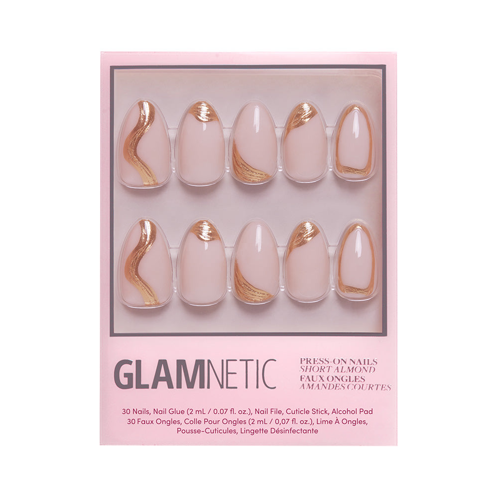 A box of glamnetic Material Girl press-on nails features a pink base with gold foil in a short almond shape, displayed in two rows inside clear packaging with bold branding and a list of included items. - Product image