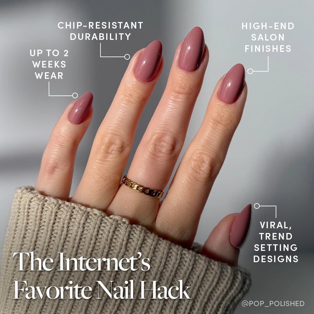A hand with long, almond-shaped mauve nails wears glamnetic’s Mauve Obsession press-ons, featuring chip-resistant durability, a glossy finish, up to 2 weeks' wear, high-end salon quality, and viral trend-setting designs. - Product image