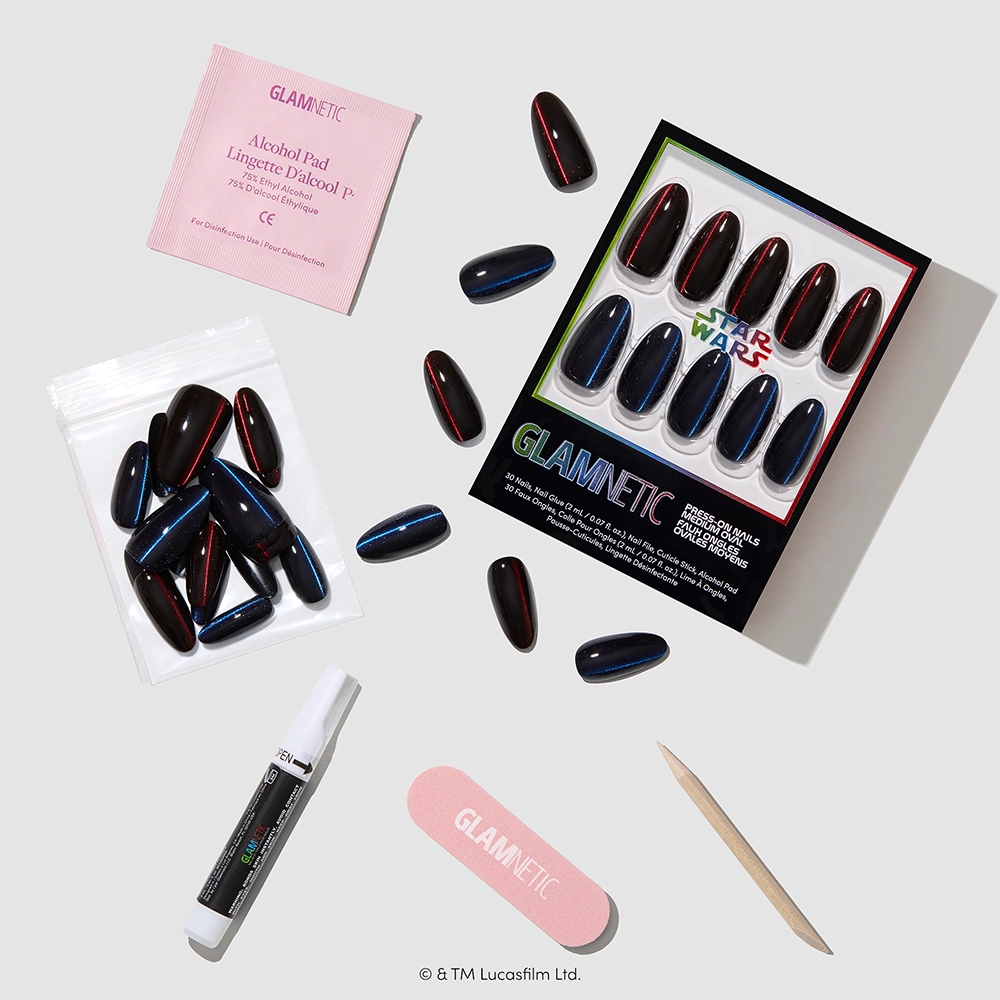 The May The Force Be With You nail set by glamnetic features STAR WARS-inspired press-on nails in bold black and red with a velvet top coat, along with an alcohol pad, glue, nail file, and wooden cuticle stick neatly arranged on a white surface. - Product image