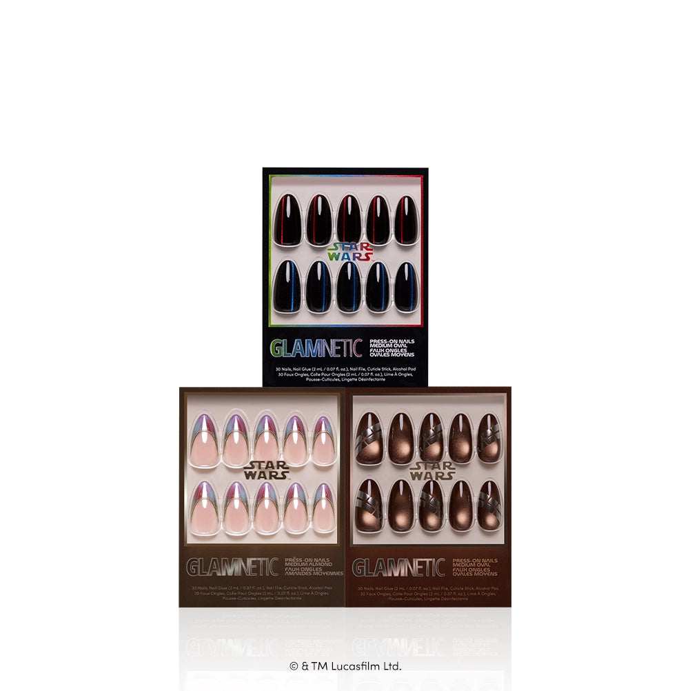 Mediums Across the Galaxy - Three sets of glamnetic’s “Mediums Across the Galaxy” STAR WARS press-on nails—in black, nude with chrome tips, and metallic brown—are displayed in branded packaging. These medium-length nails deliver salon-quality results inspired by a galaxy far, far away.