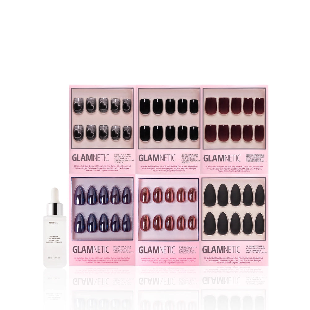 Six sets of glamnetic press-on nails, including the Meet At Midnight almond and chrome styles, are shown in pink packaging. A white dropper bottle is positioned to the left, all set on a clean white background. - Product image
