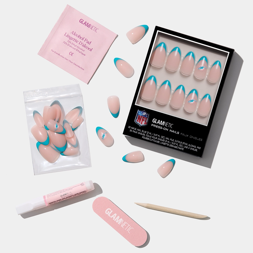 The glamnetic Miami Dolphins Press-On Nail Set features pink and blue press-on nails with extras like nail glue, a pink file, cuticle stick, alcohol pad, and extra nails—all displayed on a white background. - Product image