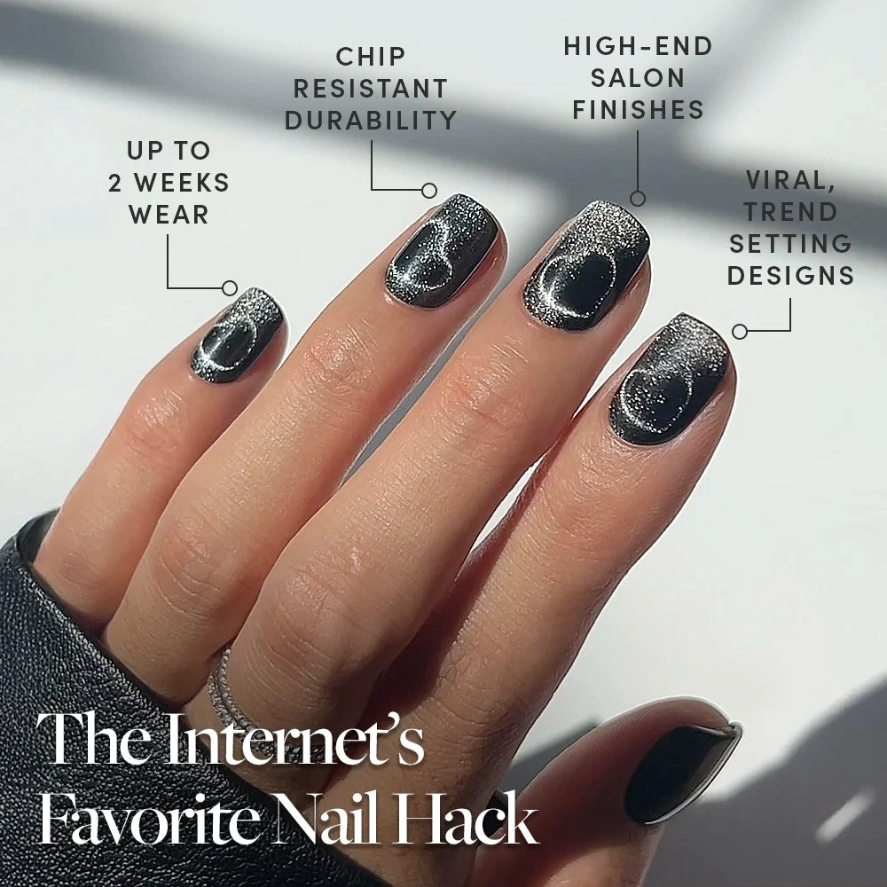 A hand with shiny black and silver gradient Midnight Romance press-on nails by glamnetic, featuring circular designs. Text highlights durability, trendy designs, salon finish, 2-week wear: The Internet’s Favorite Nail Hack. - Product image