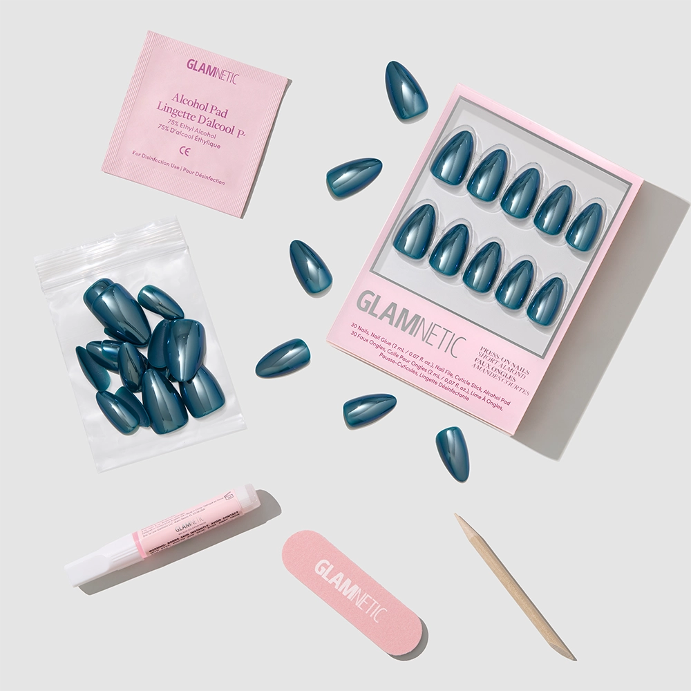 The glamnetic Midnight Teal set includes short almond press-on nails plus glue, nail file, cuticle stick, alcohol pad, and extra nails—everything for a salon-quality mani at home. - Product image