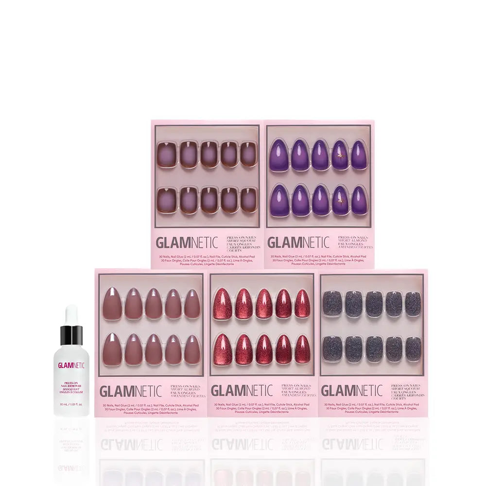 Five sets from the glamnetic Moon Child Collection, each packaged in pink boxes and showcasing a variety of colors and shapes from classic to trendy short almond styles, are arranged neatly in two rows. To the left of the nail sets sits a small glamnetic bottle with a dropper. - Product image