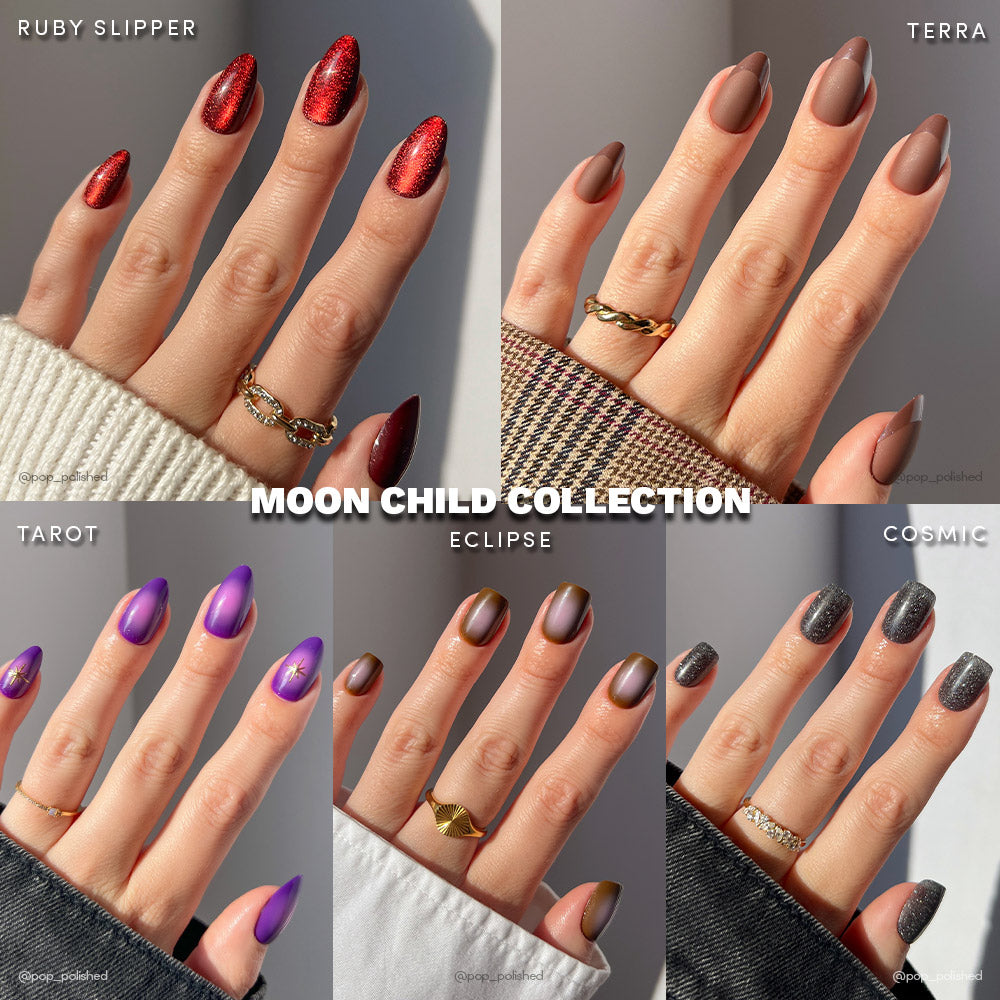 The Moon Child Collection by glamnetic showcases short almond press-on nails in red glitter, matte brown, purple, nude with gold accents, and grey shimmer—all styled on six hands for easy, stunning nail looks. - Product image