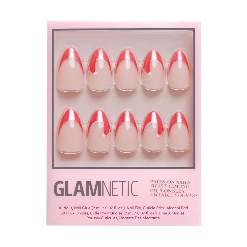 The glamnetic Mrs. Claus set features short almond press-on nails with red French tips and Santa hat accents. Includes 30 nails, glue, file, cuticle stick, and alcohol pad, all in a pink box. - Product image