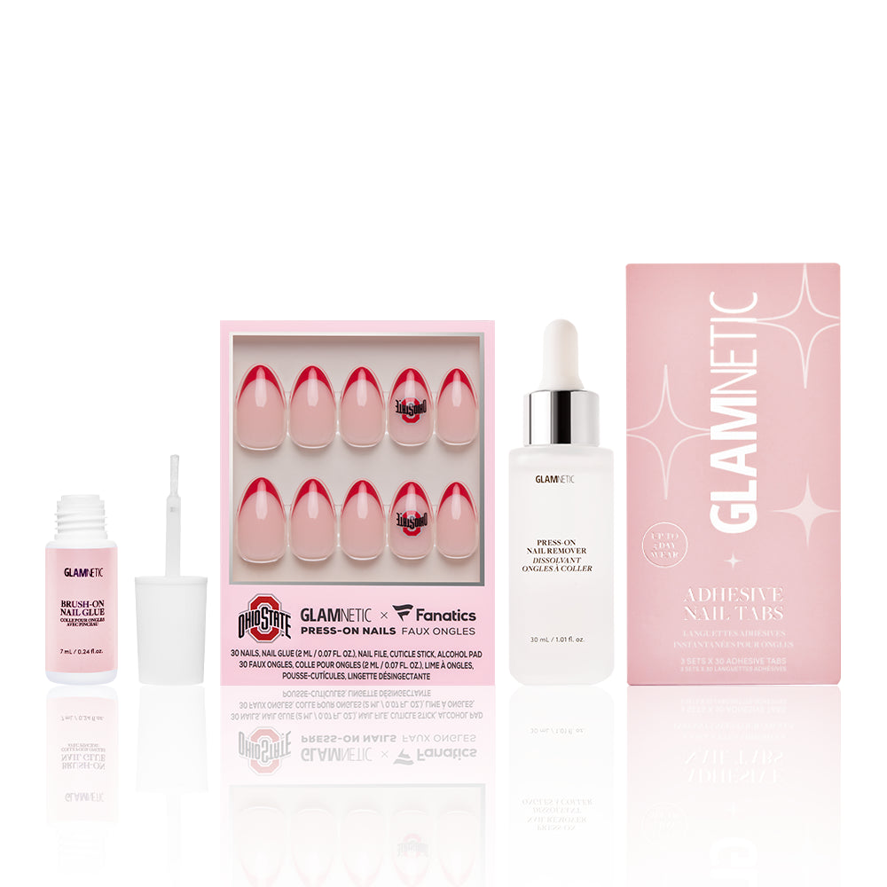The Ohio State Buckeyes Gameplan by glamnetic includes red French tip and Ohio State Buckeyes press-on nails, plus adhesive nail glue, cuticle oil dropper, and adhesive tabs—all packed in chic pink and white boxes. - Product image