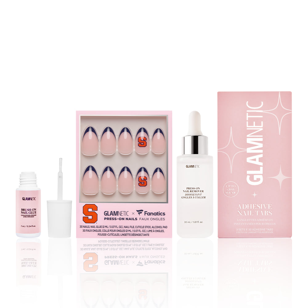 The Syracuse Orange Gameplan by glamnetic: a game day nail set with Syracuse Orange S logo press-ons, nail glue, adhesive tabs in a pink box, and a white dropper bottle, all displayed upright on a white background. - Product image