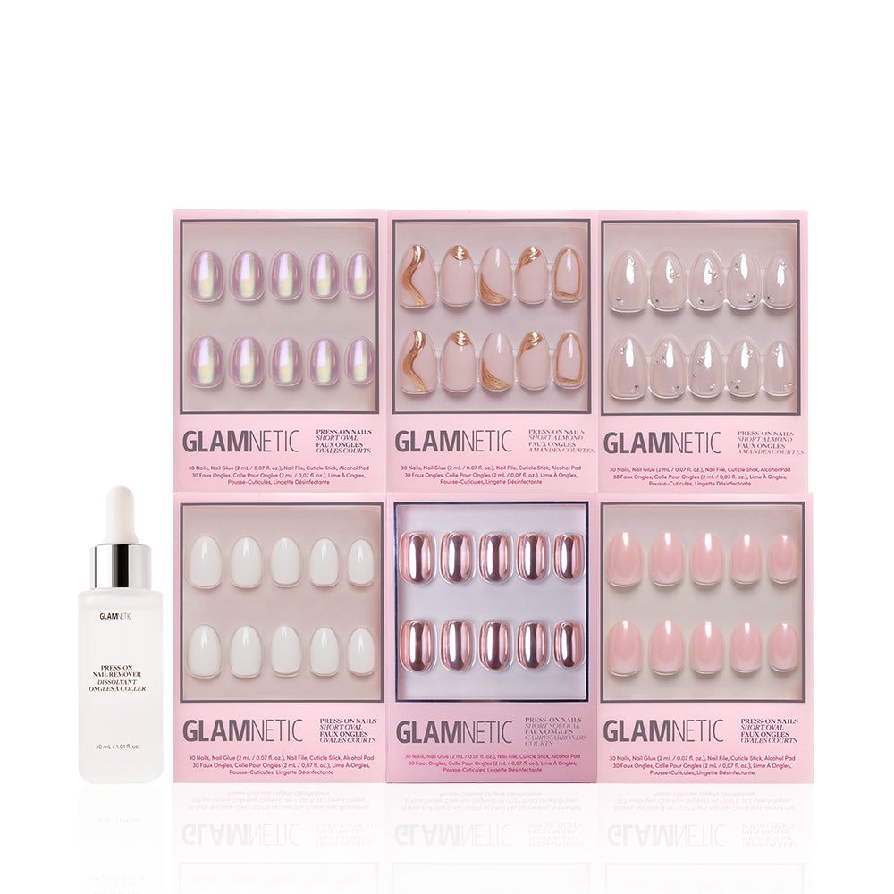 Six sets from the glamnetic NYE Rendezvous Bundle in pink, nude, and iridescent styles are shown in pink boxes. On the left is a white glamnetic cuticle oil bottle with dropper for a soft glam nails finish. - Product image