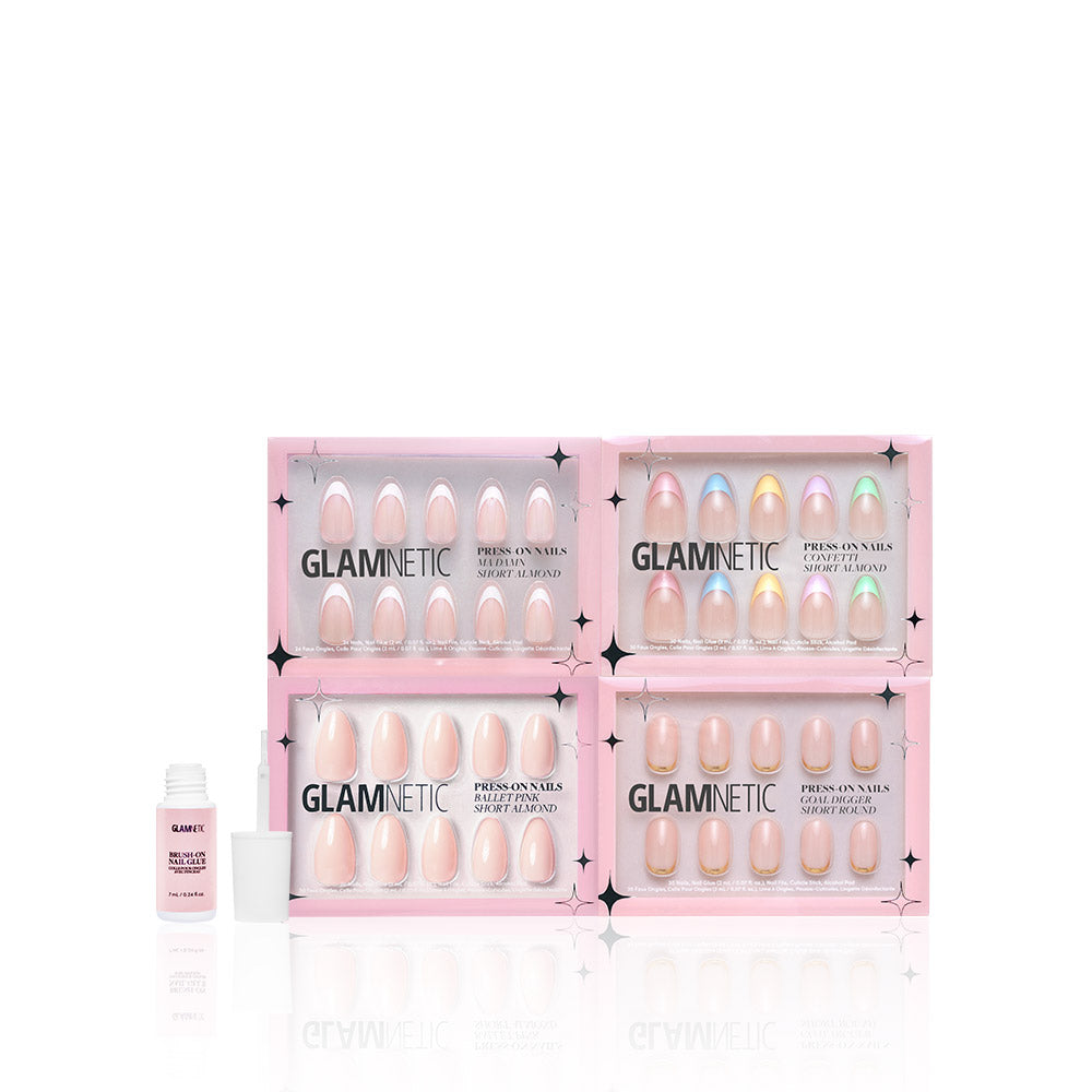 Four pink boxes of glamnetic Nail Obsessed press-on nails are arranged in a grid, featuring Confetti Ballet Pink designs. A small white bottle of glamnetic Nail Glue sits to the left, all set against a white background that showcases the pastel nail art. - Product image